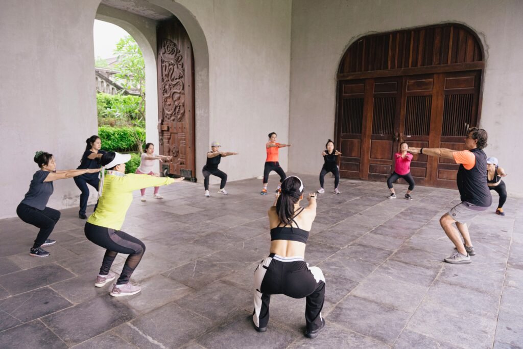 Vietnam Detox guests practising functional squats during a movement class