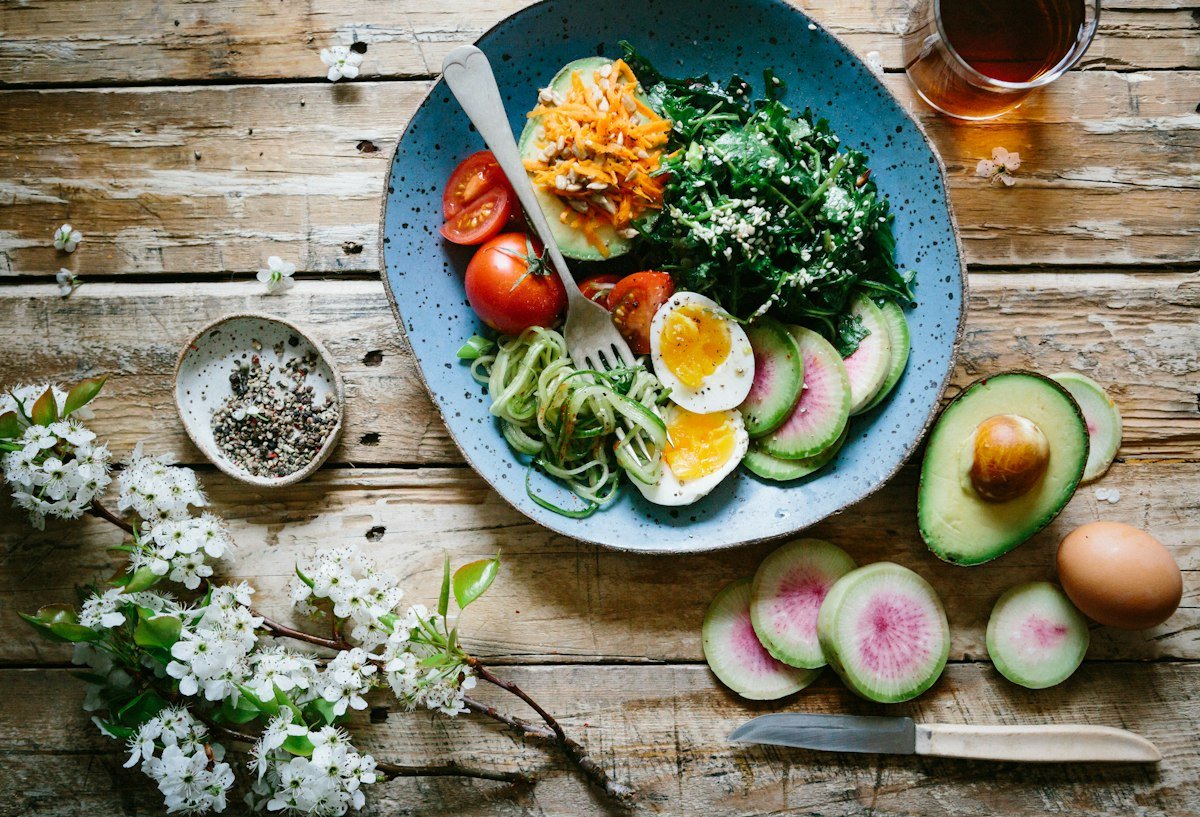 Healthy meal preparation with fresh ingredients arranged on a wooden cutting board